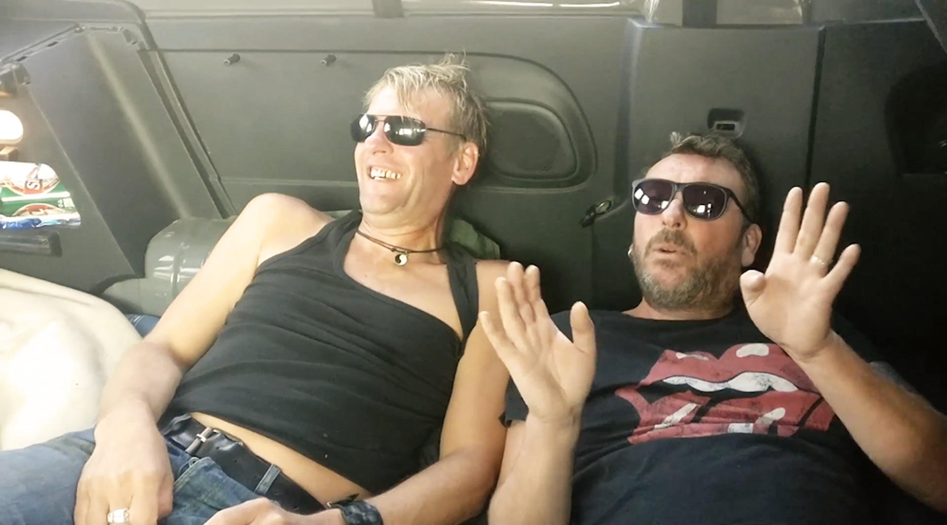 Steve and Jurgen laying and singing in the back of our van